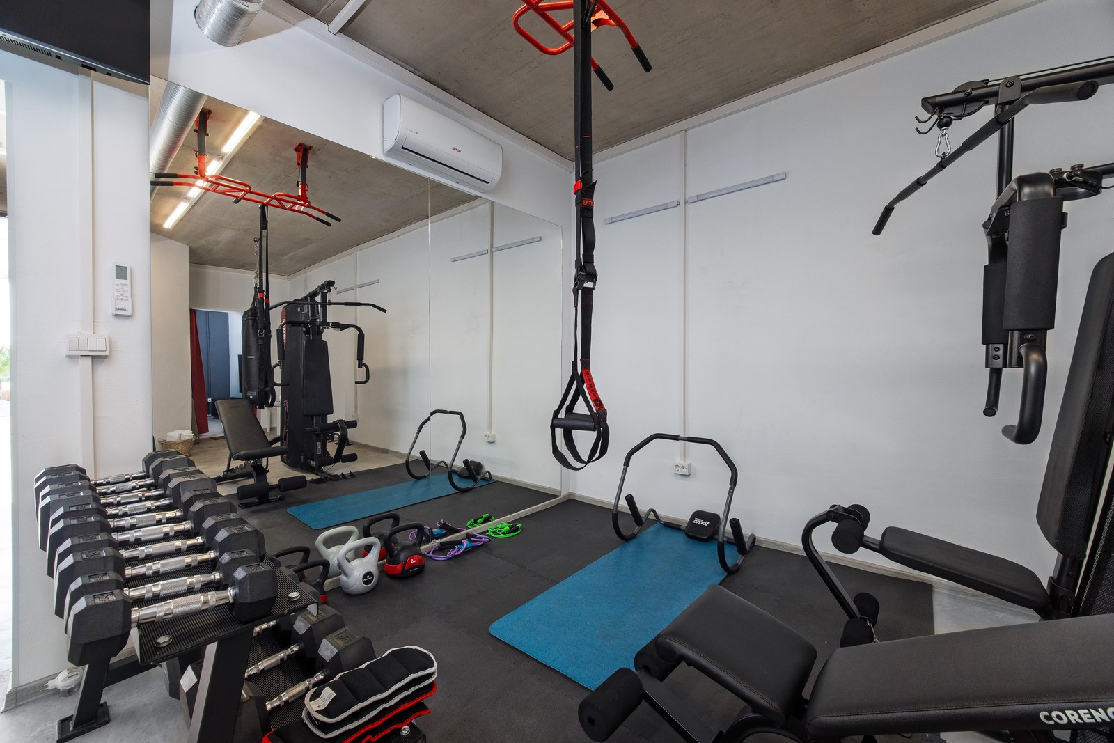 Private gym with weights, exercise mats and strength-training equipment